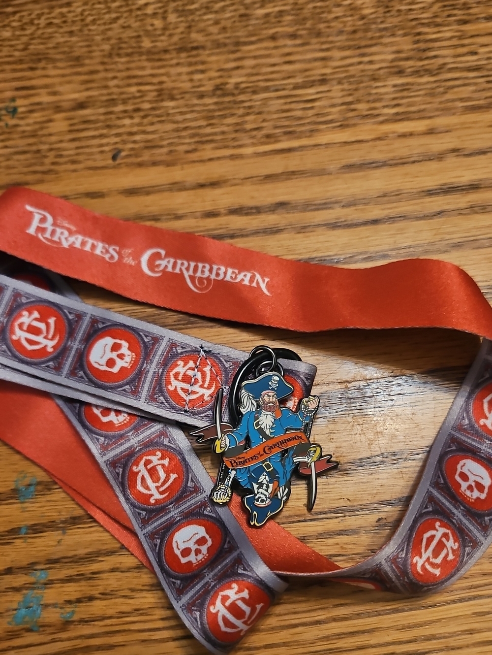 Disney Pirates of the Caribbean Red and Gray Lanyard with Pirate Enamel Pin